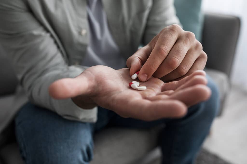 Exploring the Stages of Addiction Recovery
Addiction on pain relievers, mental health problems, antidepressants. Young man taking medication, feeling ill. Frustrated sad millennial guy sit on couch with many pills on hand, cropped, close up